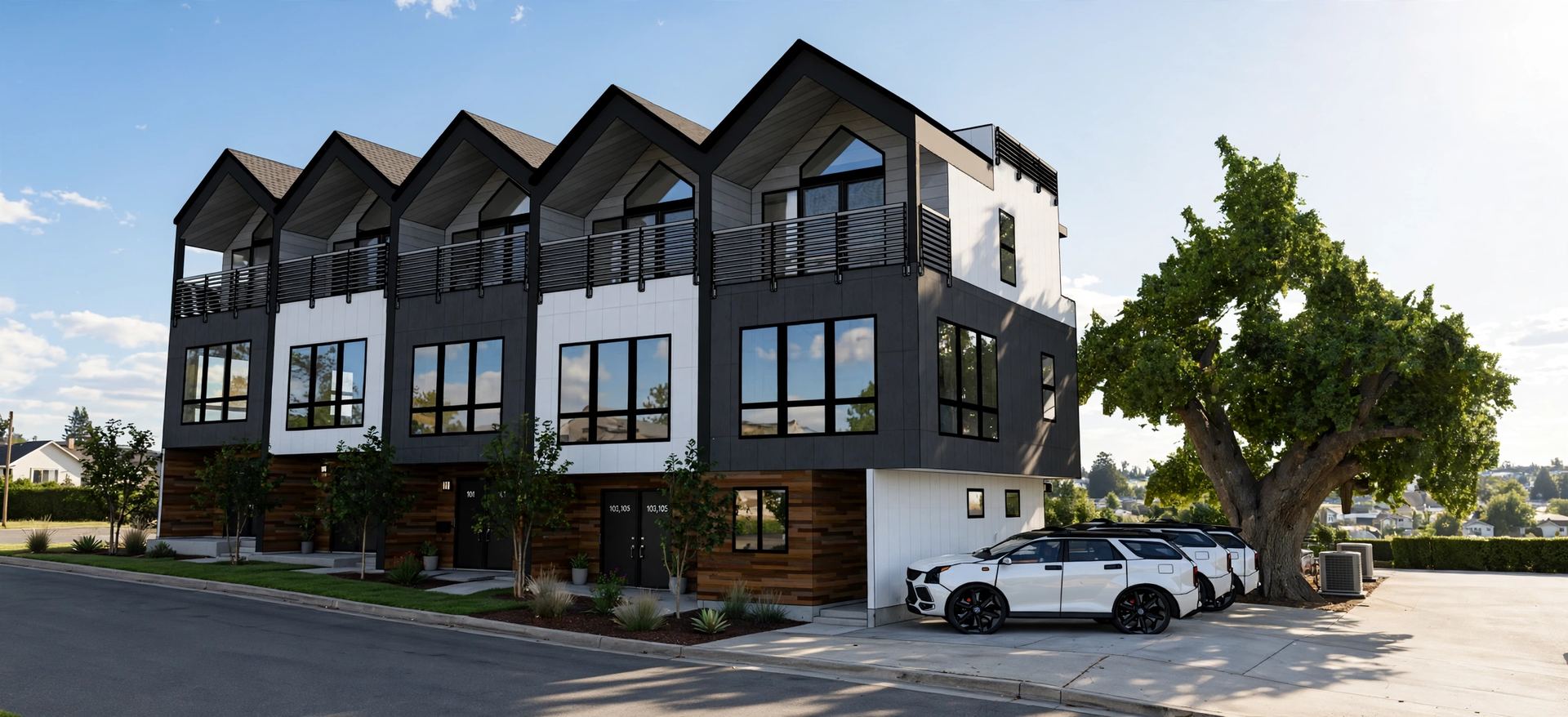 Townhouse row with repeating gabled rooflines, balconies and alley-facing garages